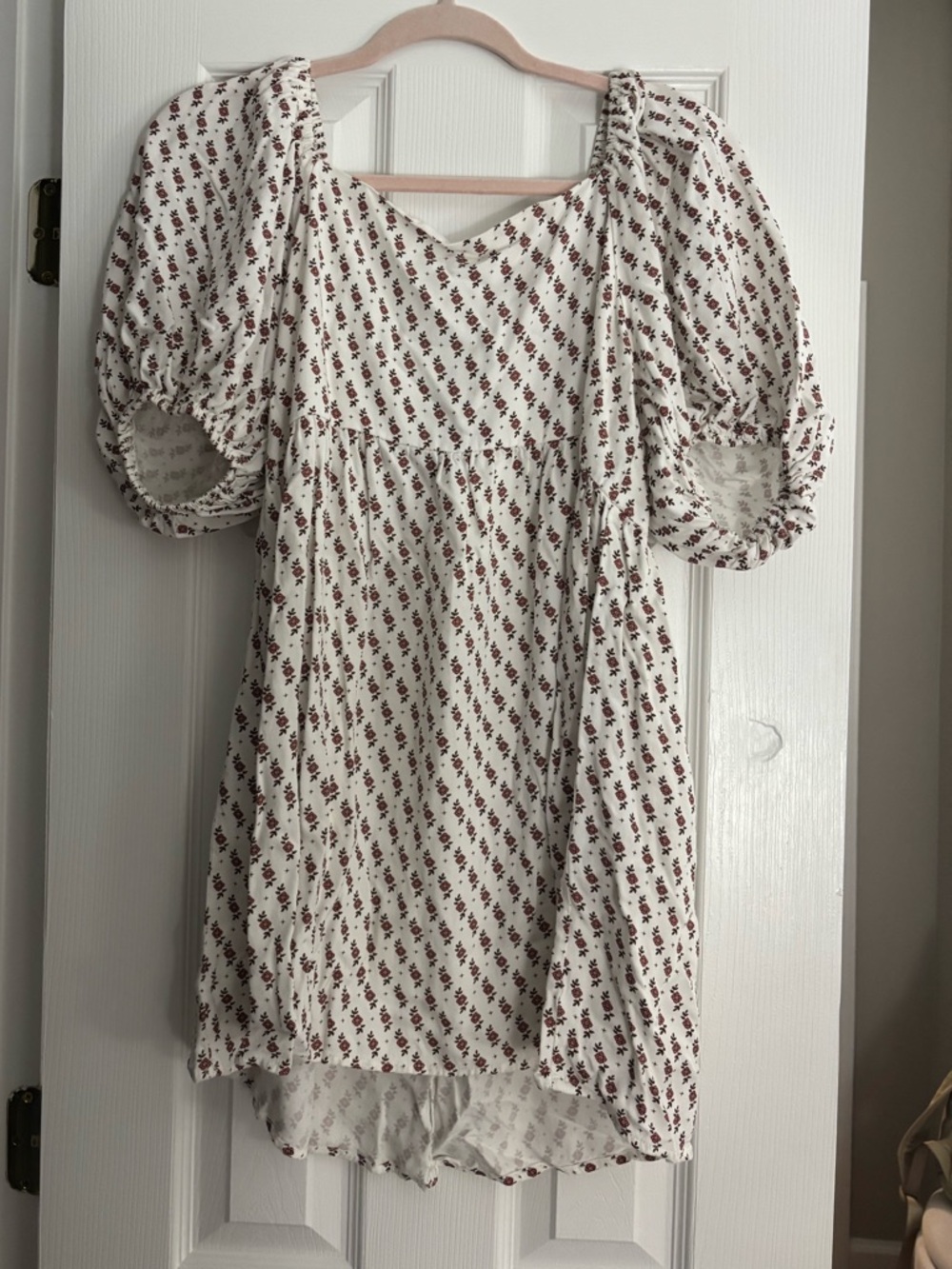white mini dress with flower pattern, ties in back